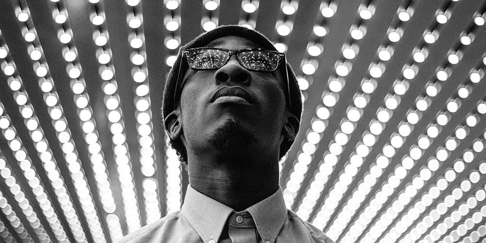 man looking at lights b&w